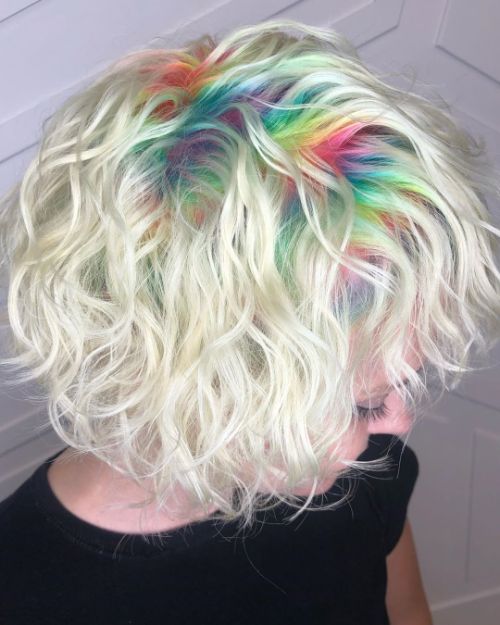 curly blonde hairstyle with colorful roots