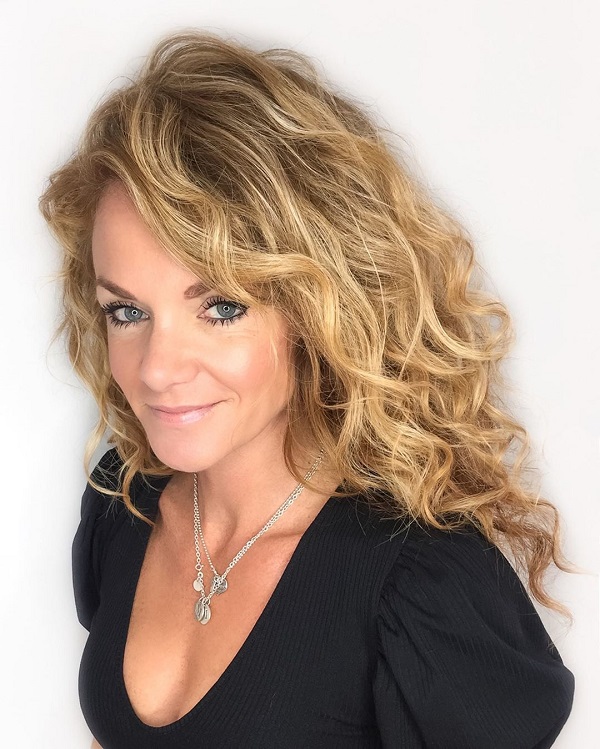 long hairstyle for women over 50 with big voluminous curls