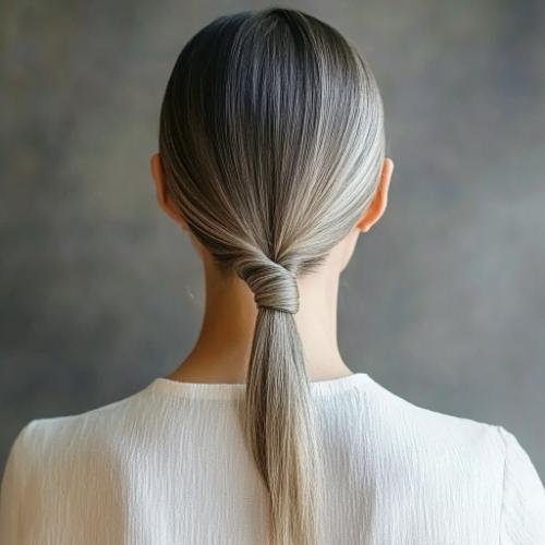 Low twisted gray ponytail for an older woman